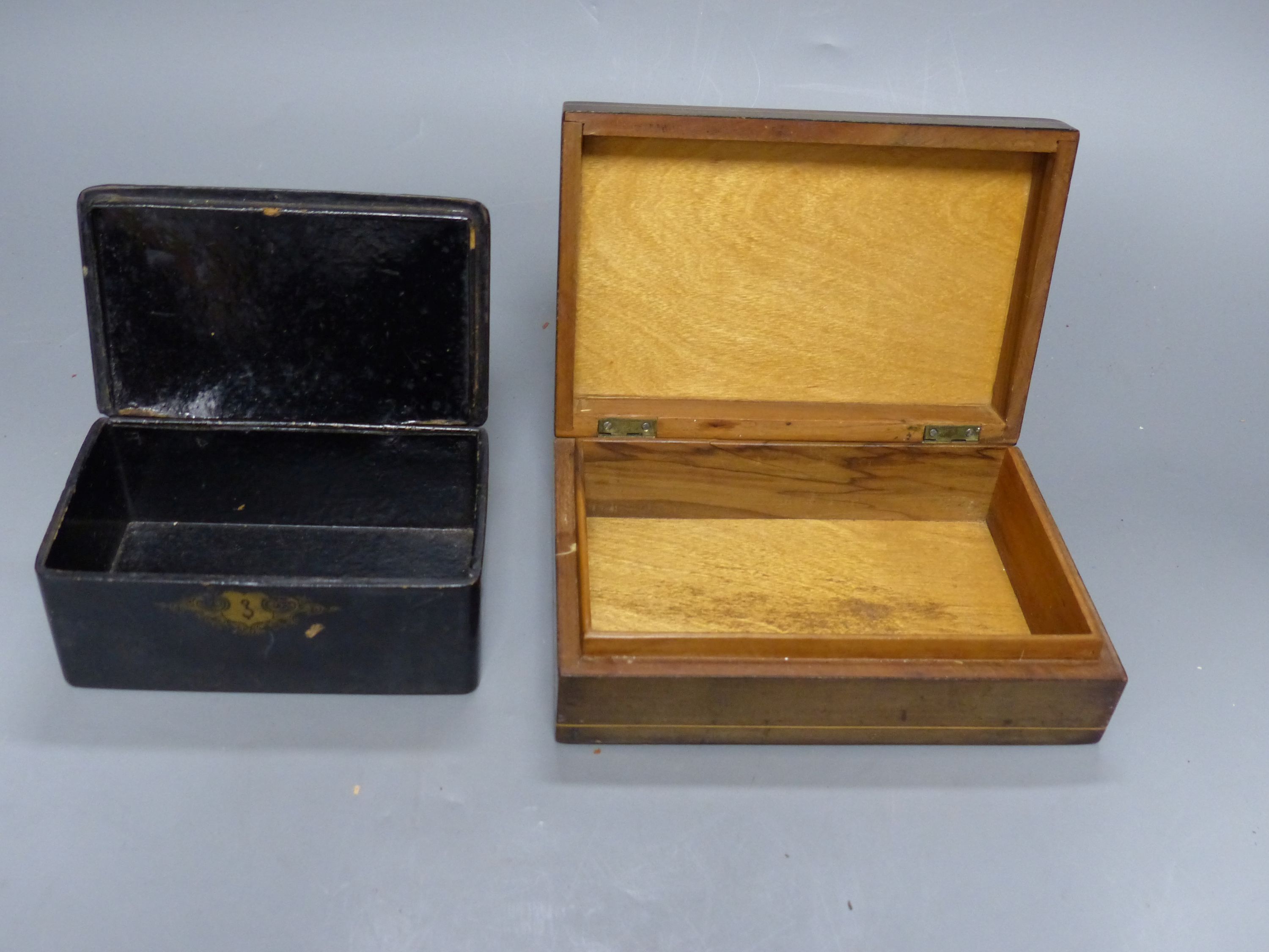 A mother of pearl inlaid lacquer writing box, two smaller boxes and a circular tray